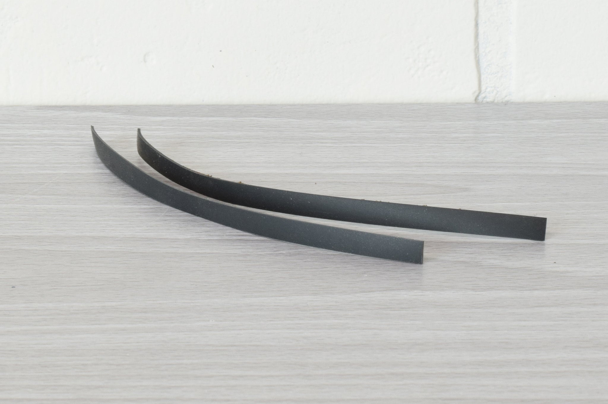 a set of black anti slip pads sitting on a gray table with a white background