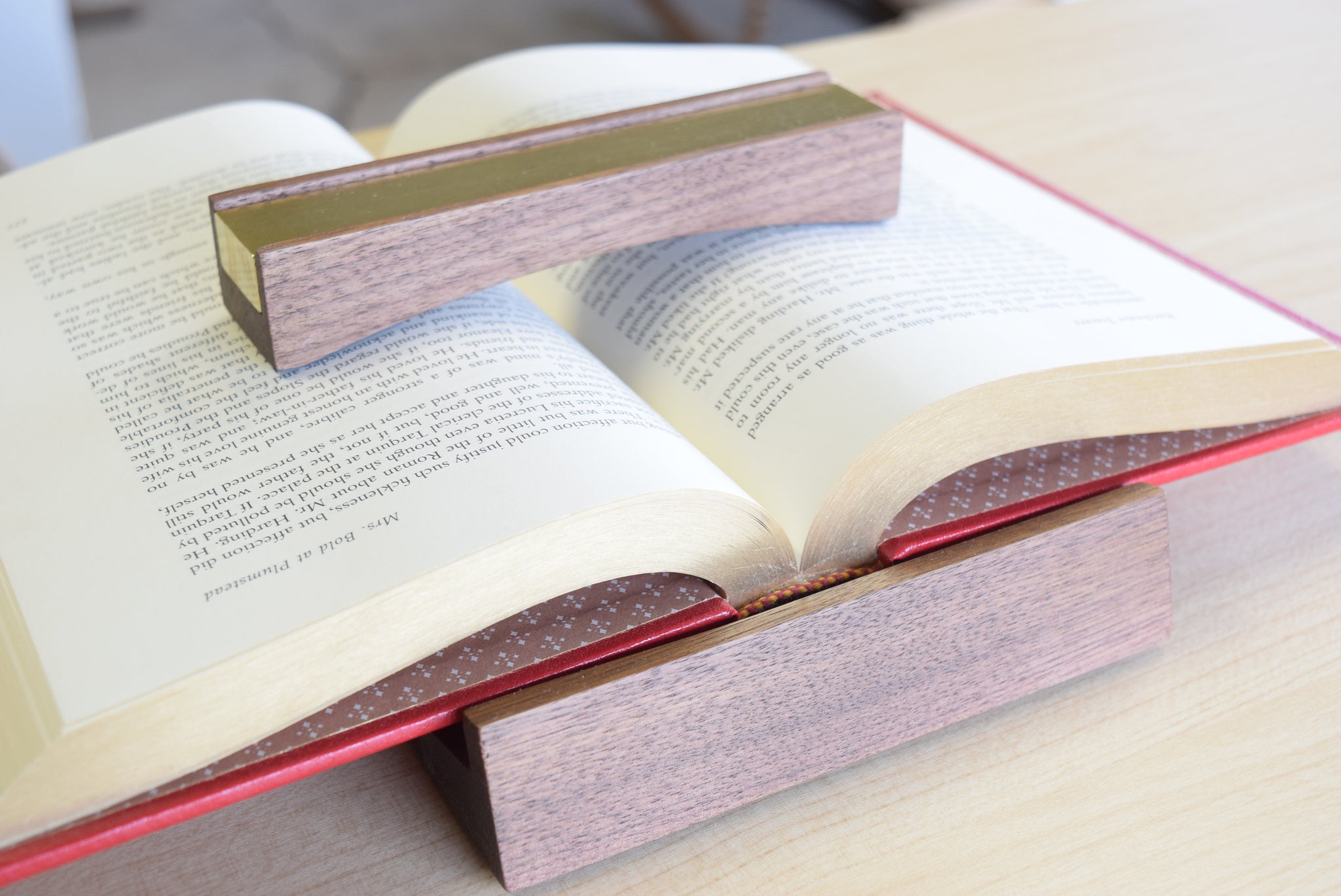 Good Made Better Bookfellow in walnut and brass. A heavy book weight and book rest.