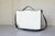 White Writewell with black strap on a light wooden floor