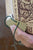 Hand inserted in a book clip holding a book open showing the straps for the hand