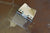 Tan book clip shown in open position on a brown surface