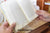 An open book being inserted into the reader's kit on a wooden portable desk