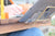 An up close picture of the reader's kit holding a tablet on the writewell lap desk