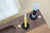 Pencil and pen being shown fit in foam holders on a portable wood desk
